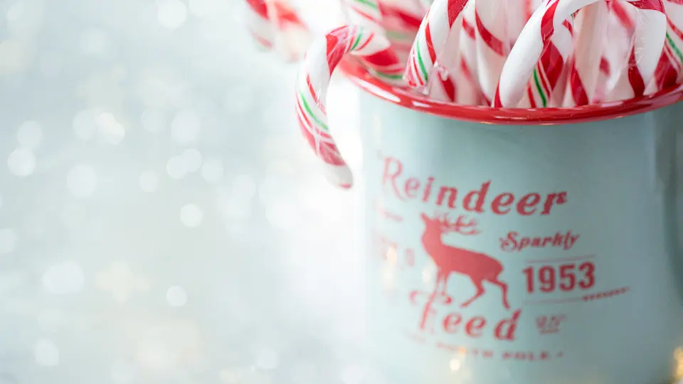 Röda och vita juleklubbor i en liten kopp